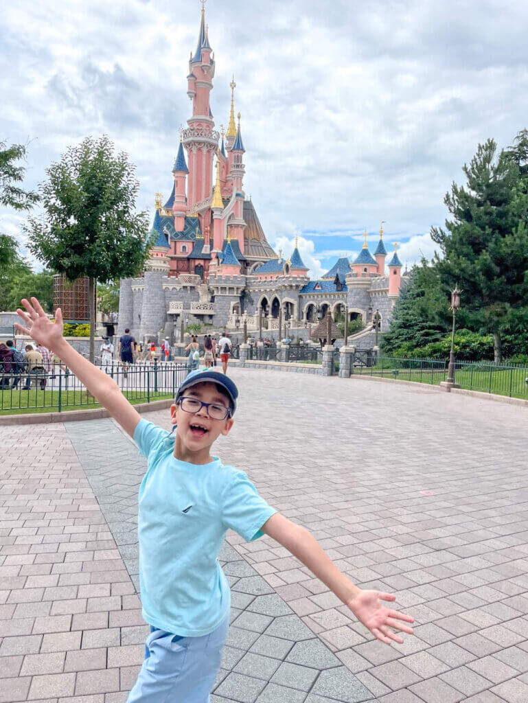 Image of a boy posing in front of the Disneyland Paris castle