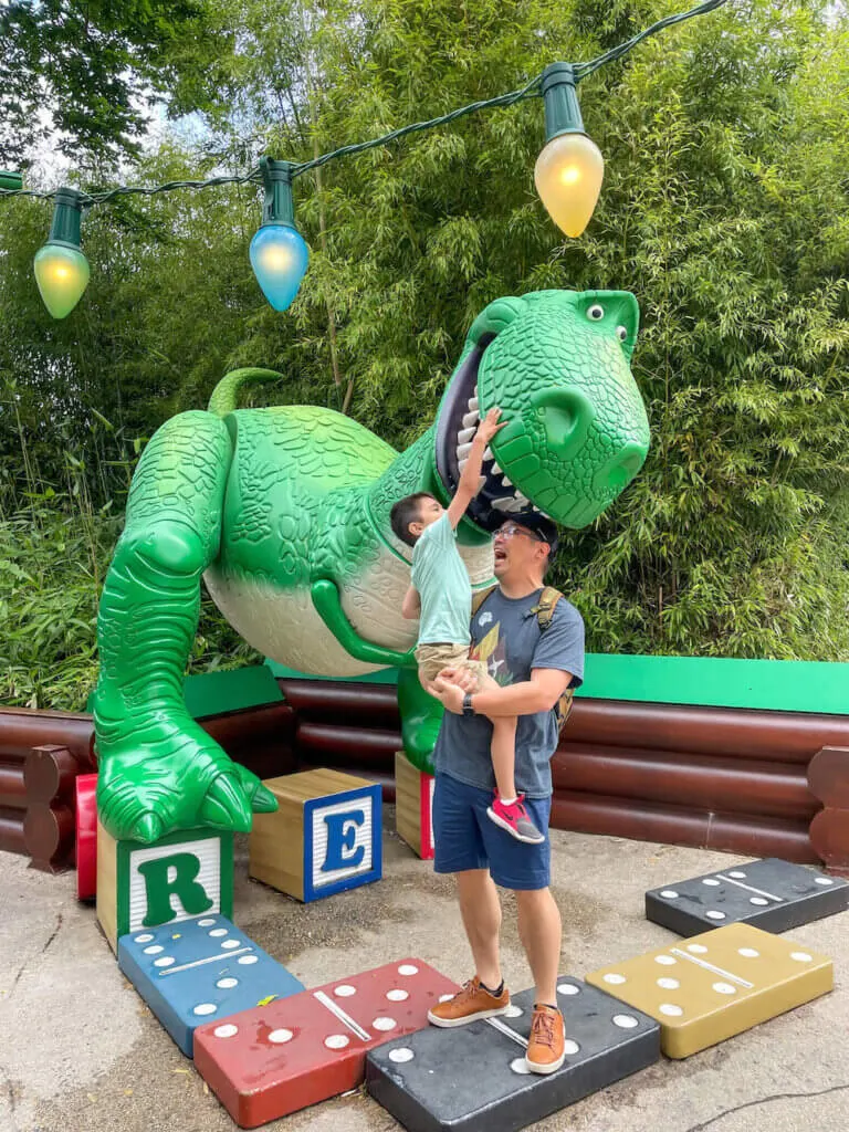 Image of a dad and boy with Rex from Toy Story