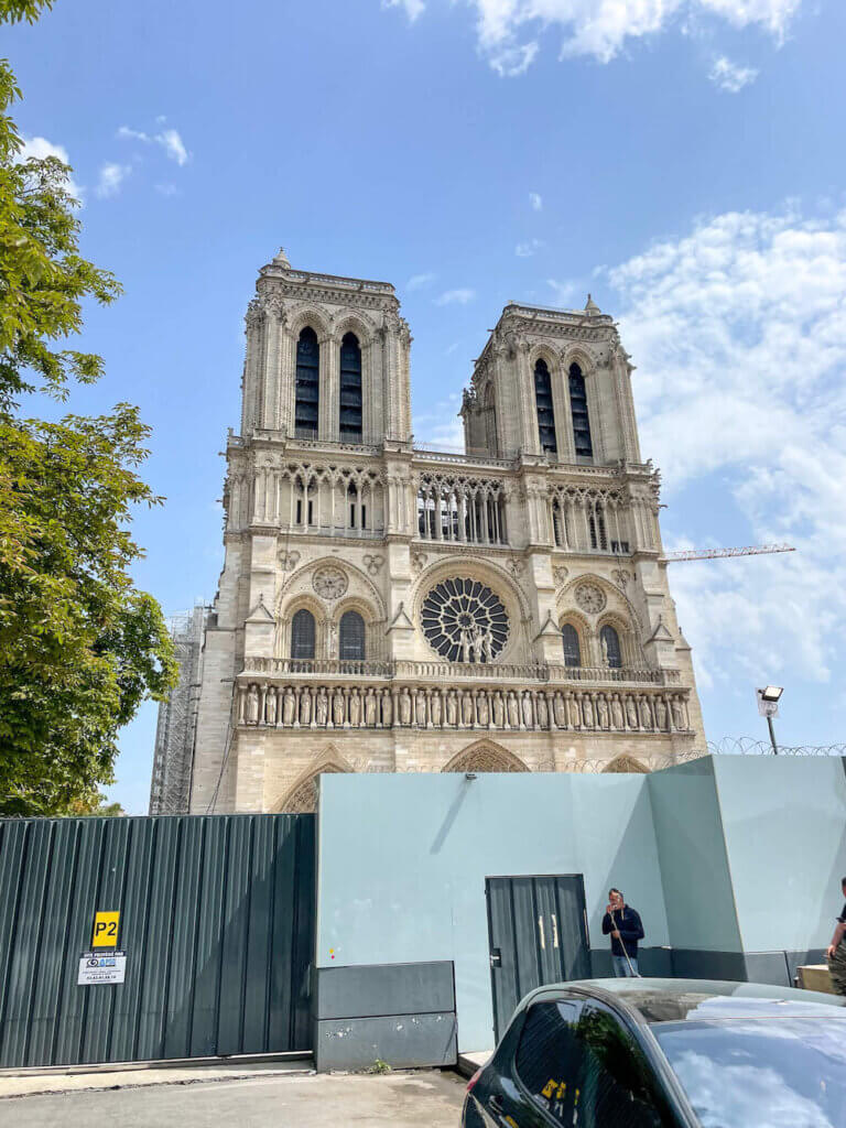 Image of Notre Dame cathedral with a construction wall around it