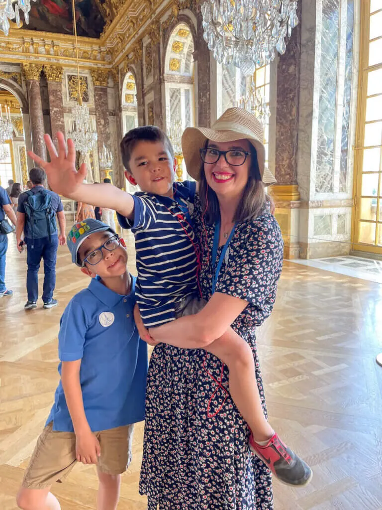 Image of a mom and two boys inside the Palace of Versailles