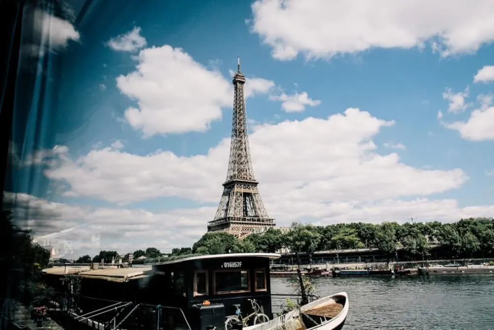 Image of a boat in the river with the Eiffel Tower in the background