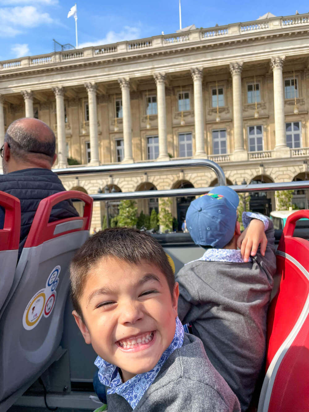 Image of a boy smiling on a double decker bus in Paris