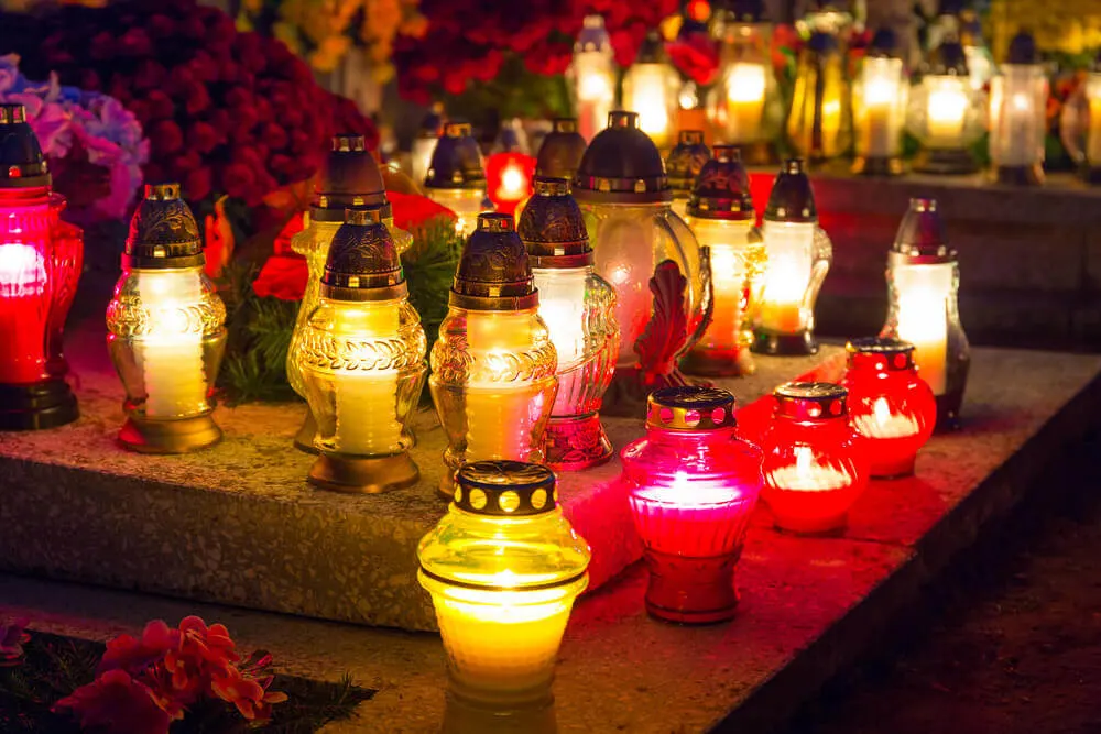 Image of candles on a grave for All Saints Day in France.