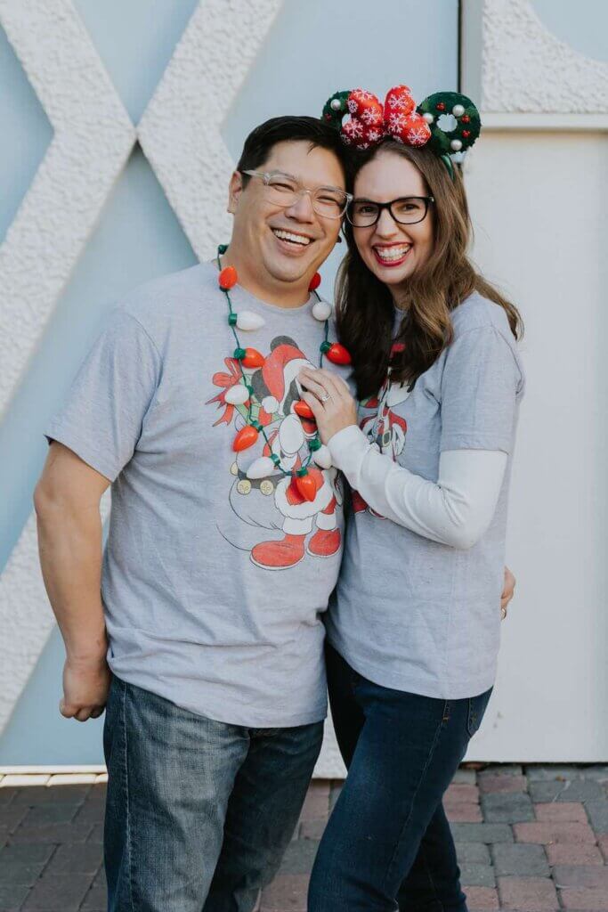 How to Book a Fun-Filled Disneyland Photography Session: Image of a couple wearing Christmas clothing at Disneyland Resort.