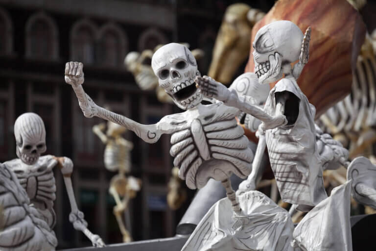 Check out these amazing Halloween traditions from around the world suggested by top family travel blog Marcie in Mommyland. Image of skeletons