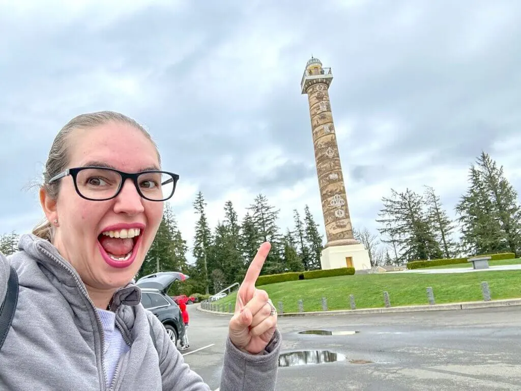 Image of a woman pointing to the Astoria Column