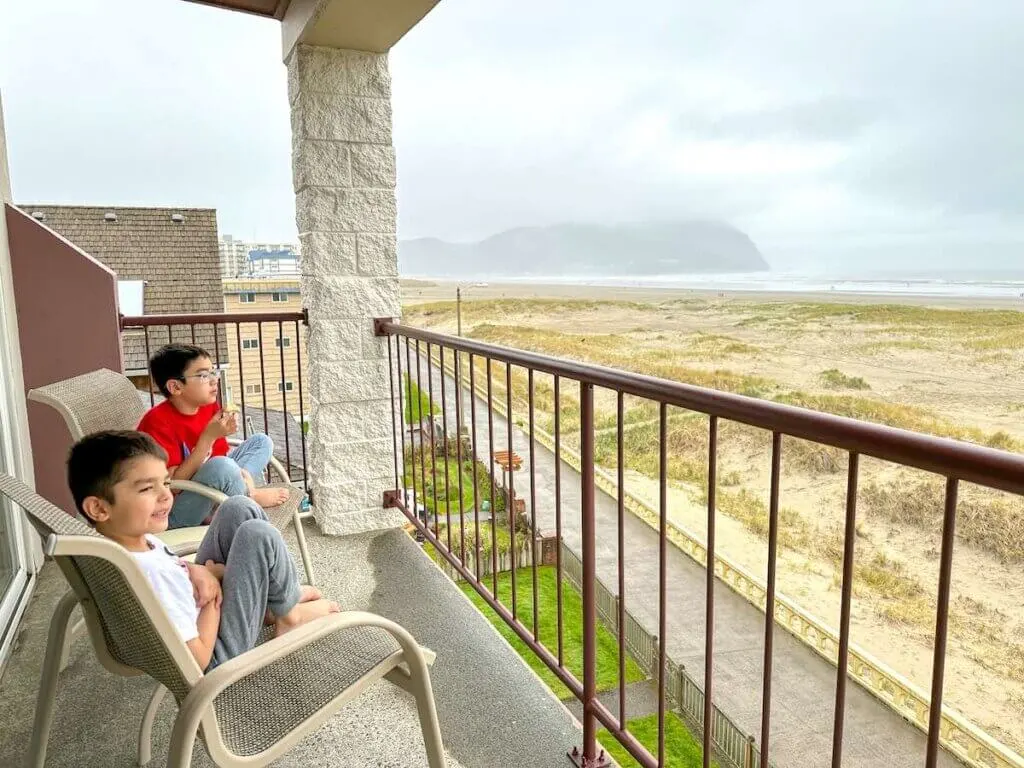 Image of two boys sitting in chairs on the deck at the Best Western Plus Ocean View Resort in Seaside Oregon