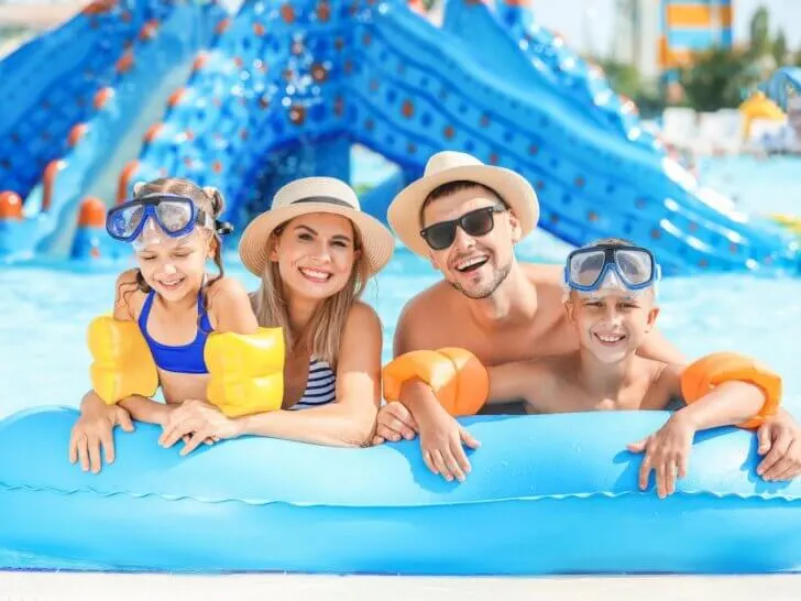 Check out the best Cabo San Lucas all-inclusive family resorts recommended by top family travel blog Marcie in Mommyland. Image of Happy family resting in aqua park