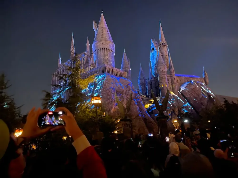 Image of people taking photos right before the Hogwarts lighting ceremony at the Wizard World of Harry Potter at Universal Studios Hollywood.