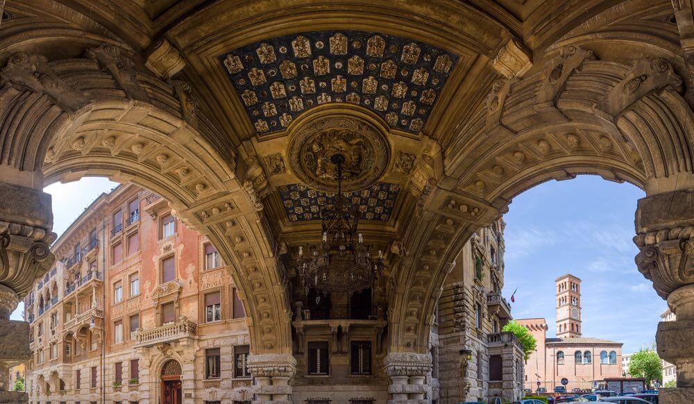 Panoramic composite of arch gallery ceiling, with stone carvings and painted patterns in Quartiere Coppedè, a 20th century Liberty Style architecture district in Rome, Italy