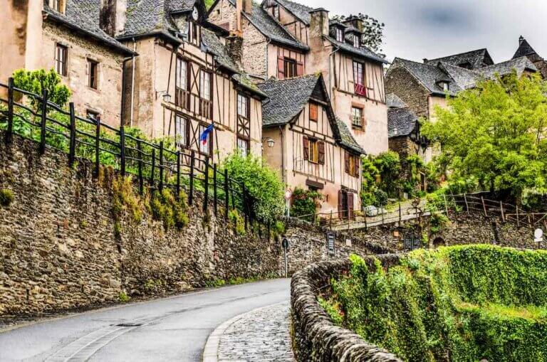 Find out the best hidden gems in France according to top family travel blog Marcie in Mommyland. Image of Located on the route of Santiago de Compostela in France we find this medieval village Conques out of a fairy book in the region of occitania