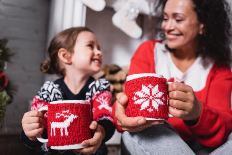 Find out the best winter break activities for families recommended by top family travel blog Marcie in Mommyland. Image of a mom and daughter holding mugs