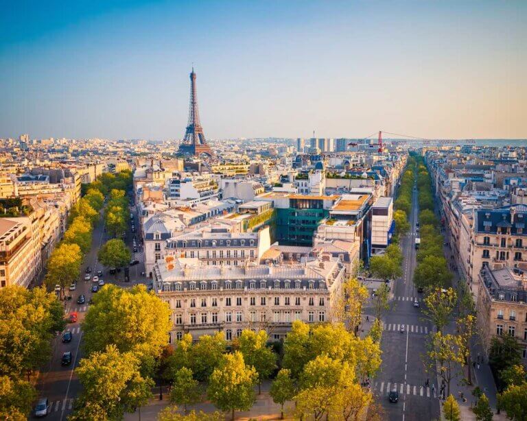 Find out the best places to stay in Paris for families recommended by top family travel blog Marcie in Mommyland. Image of View on Paris at sunset, France