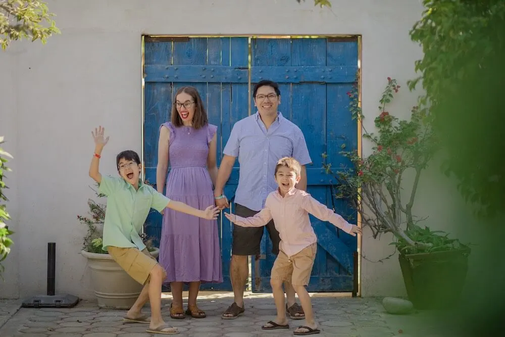 Image of a family of four in front of a blue door in Cabo San Lucas Mexico