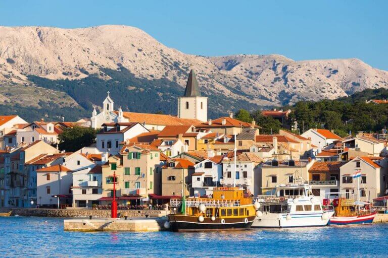Check out what's on this Europe Bucket List by top family travel blog Marcie in Mommyland. Panoramic view of Baska town, popular touristic destination on island Krk Croatia Europe.