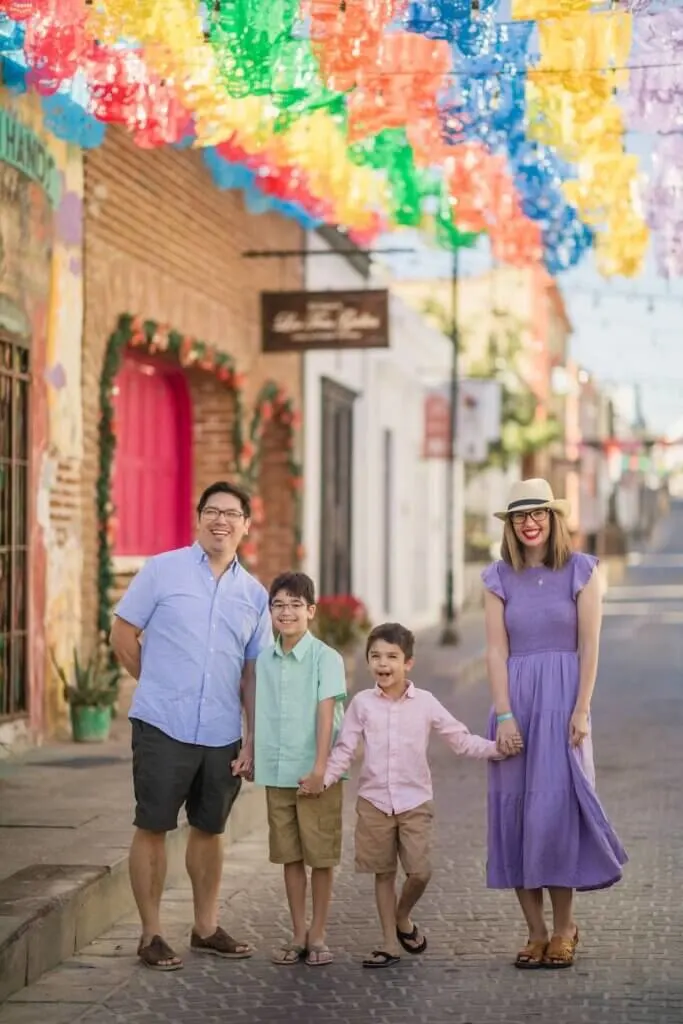 Image of a family wearing pastels walking down the street in Cabo San Lucas Mexico