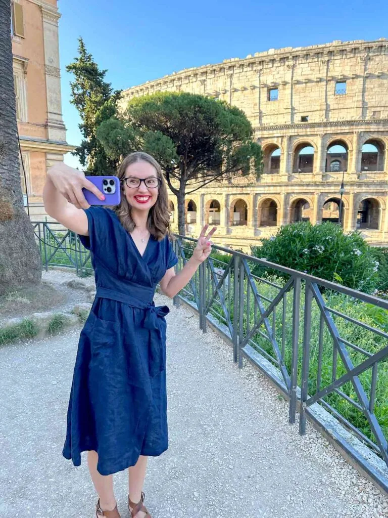 Image of a woman taking a selfie at the Colosseum in Rome Italy