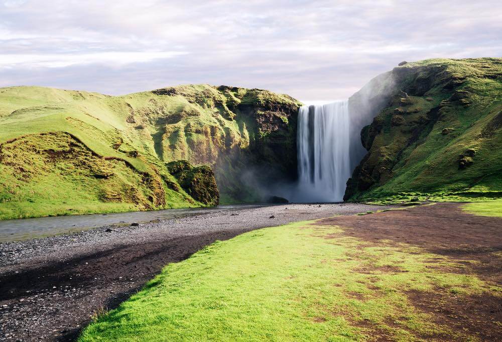 Beautiful Skogafoss Waterfall in South Iceland. Famous landmark. Summer landscape on a sunny day
