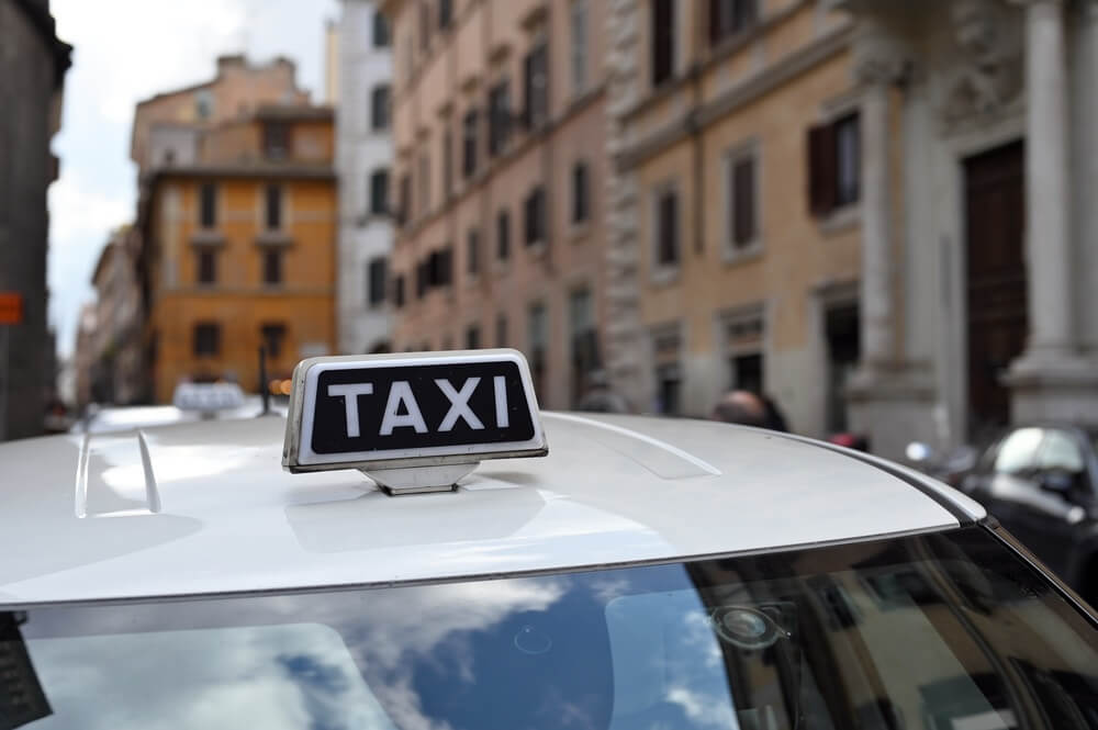 Taxi cars on the city street. Rome taxi sign, Italy