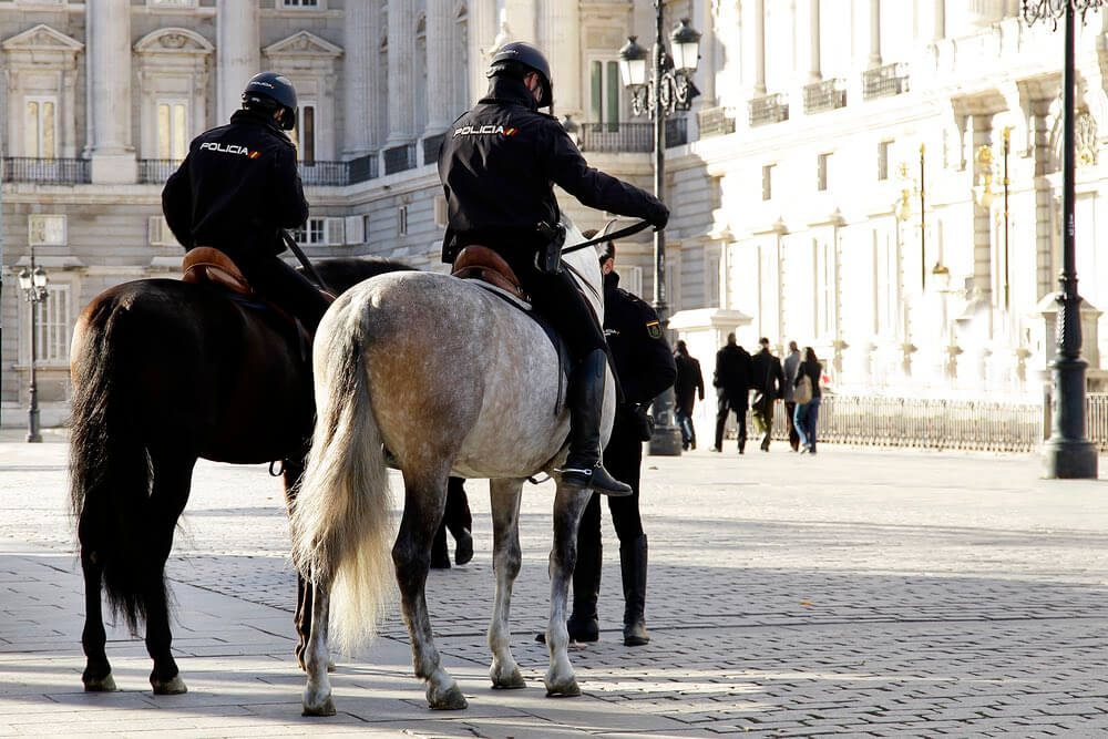 Police on horse back patrolling the Royal Palace in Madrid, Spain