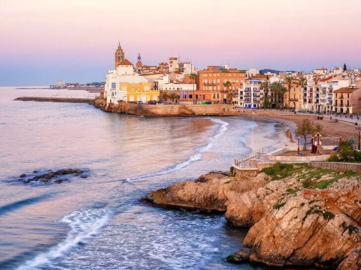 Find out the best day trips from Barcelona by train recommended by top family travel blog Marcie in Mommyland. Image of Sitges Spain