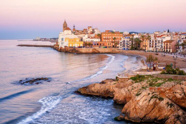 Find out the best day trips from Barcelona by train recommended by top family travel blog Marcie in Mommyland. Image of Sitges Spain