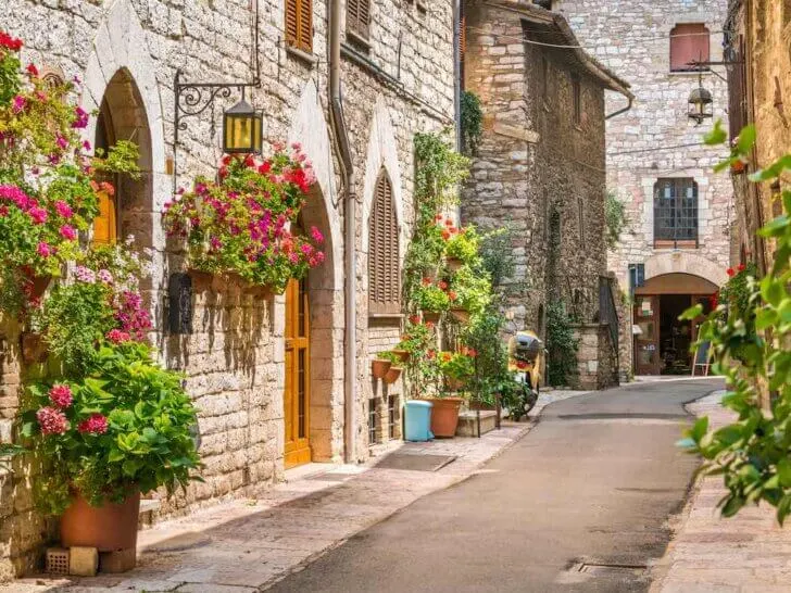Check out this list of day trips from Florence by train recommended by top family travel blog Marcie in Mommyland. Image of a cute street in Umbria Italy