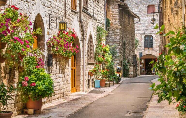 Check out this list of day trips from Florence by train recommended by top family travel blog Marcie in Mommyland. Image of a cute street in Umbria Italy