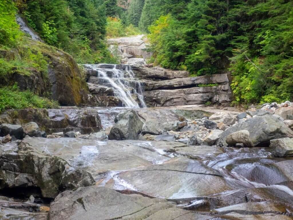 The Denny Creek Trail is extremely popular and for good reason!. A natural waterslide, two good sized waterfalls, lots of old growth forest mixed in with open areas with great views, and beautiful Alpine Lakes.