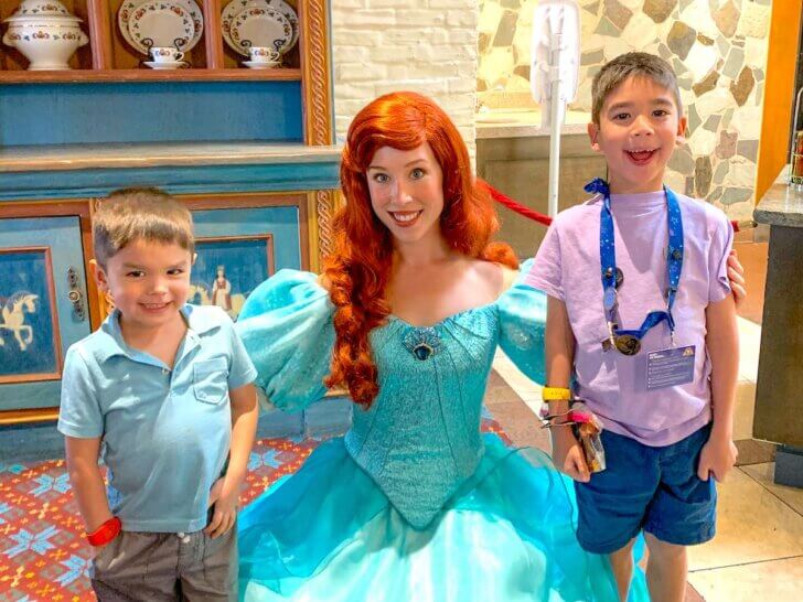 Find out what to do on your Walt Disney World arrival day by top Disney blog Marcie in Mommyland. Image of Ariel and two boys