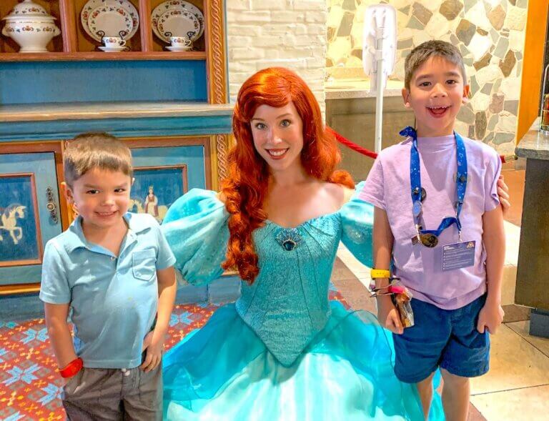 Find out what to do on your Walt Disney World arrival day by top Disney blog Marcie in Mommyland. Image of Ariel and two boys