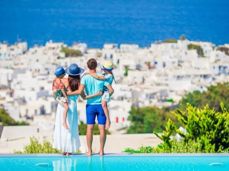 Check out these fun things to do in Greece with kids recommended by top family travel blog Marcie in Mommyland. Image of Family having fun outdoors on Mykonos island