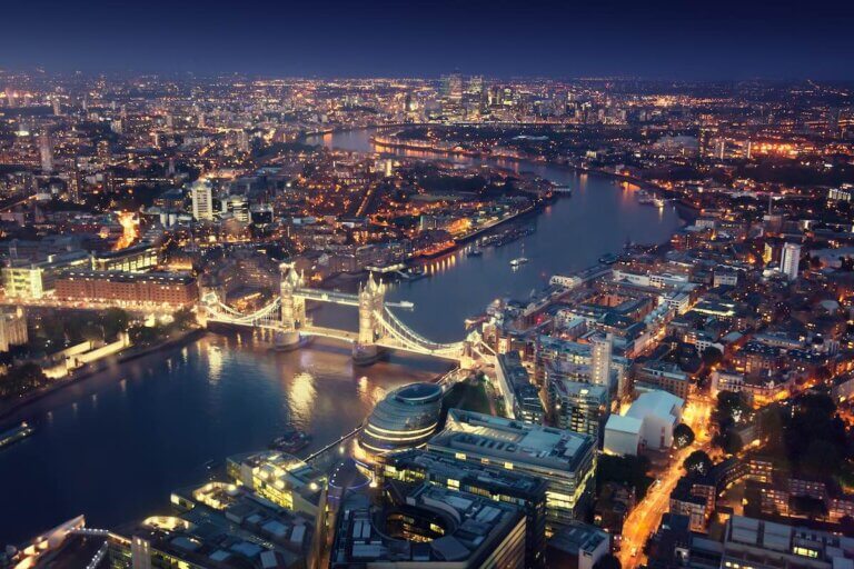Check out this list of the best things to do in London at night by top family travel blog Marcie in Mommyland. Image of London at night with urban architectures and Tower Bridge