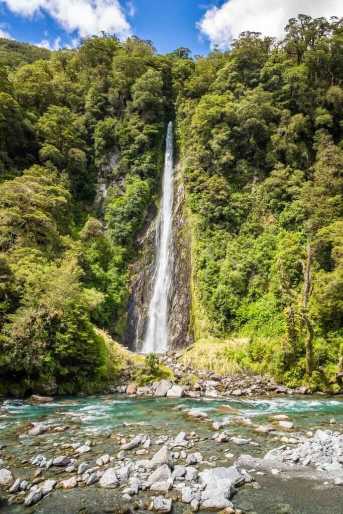 Thunder Creek Falls, a 96-metre high waterfall, cascading through the dense rainforest in the Mount Aspiring National Park on the South Island of New Zealand