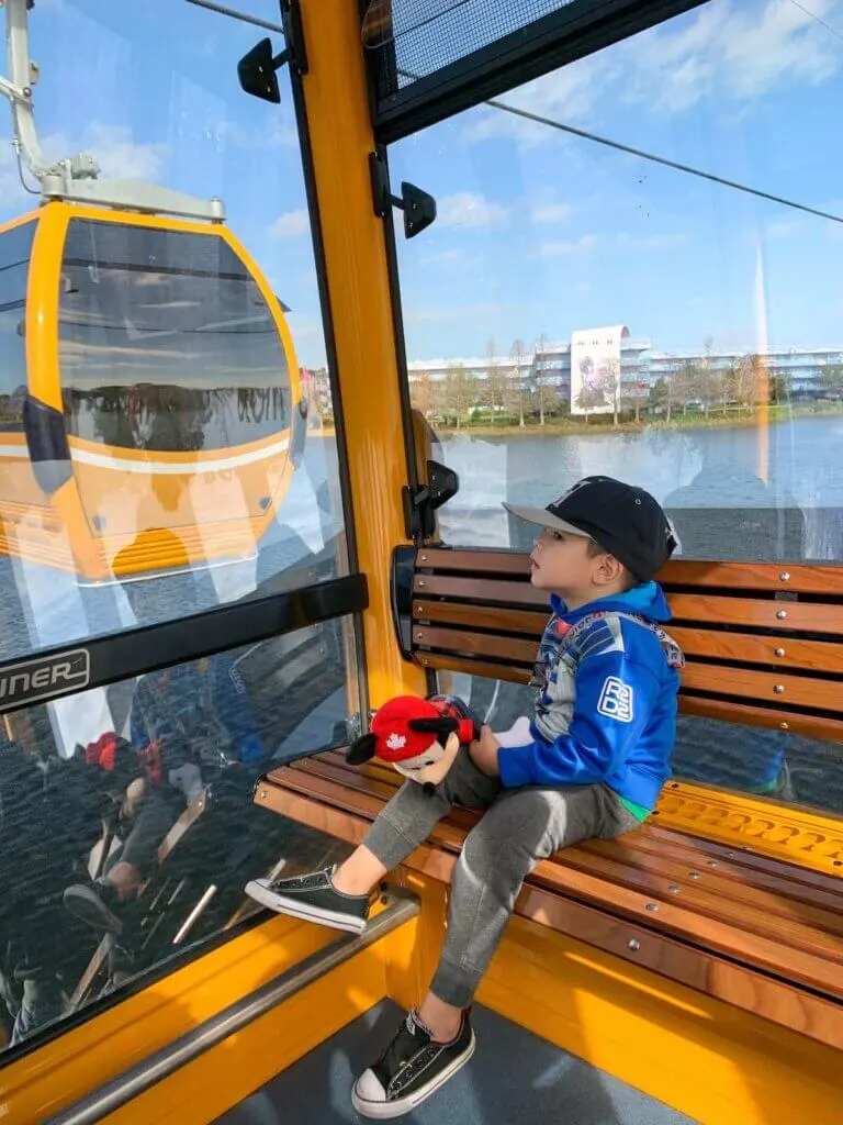Image of a boy sitting in the Disney World Skyliner