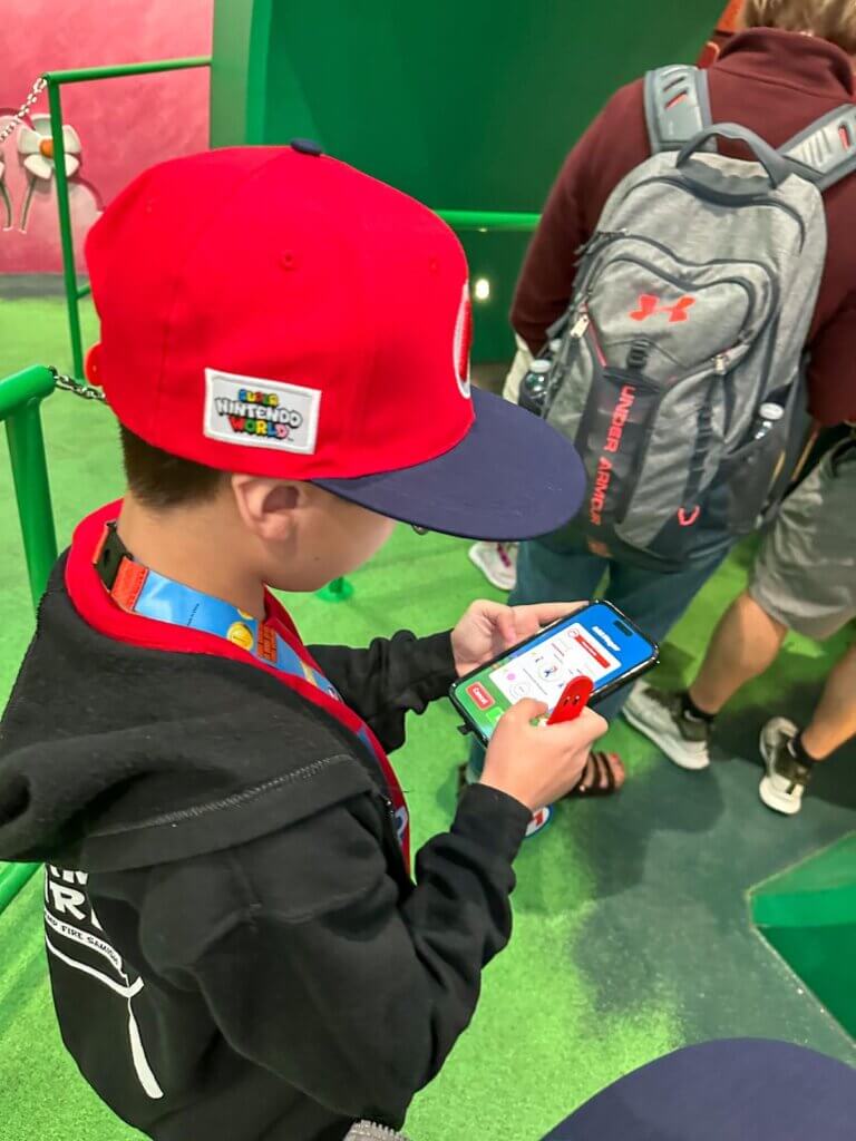 Image of a boy connecting a Nintendo Power Up band to an app