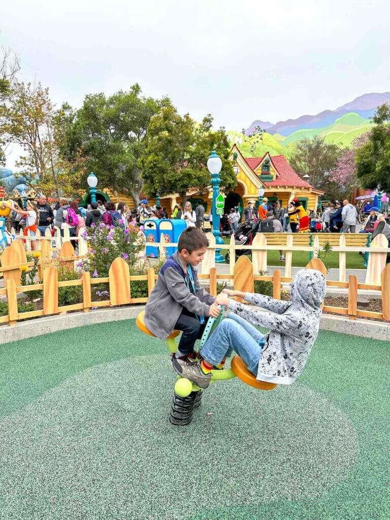 Image of two boys on a rocking toy at Disneyland Toontown