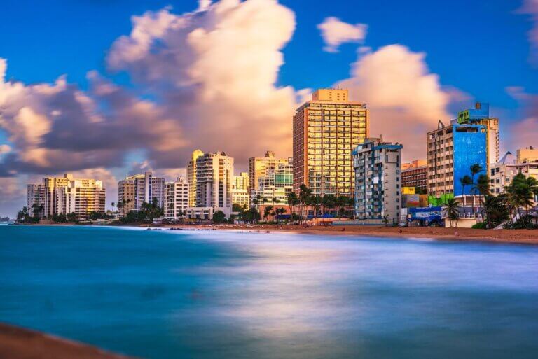 Check out this list of Best Puerto Rico Resorts for Families recommended by top family travel blog Marcie in Mommyland. Image of the San Juan skyline in Puerto Rico