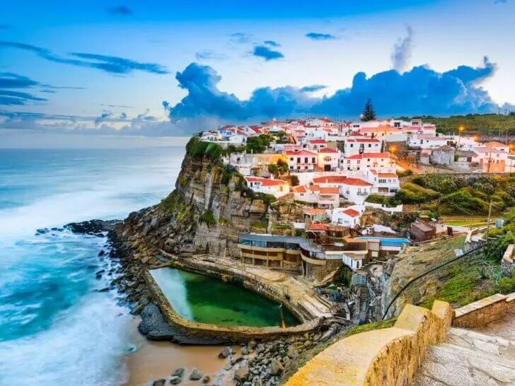 Check out these amazing day trips from Lisbon Portugal recommended by top family travel blog Marcie in Mommyland. Image of Azenhas do Mar, Portugal coastal town.