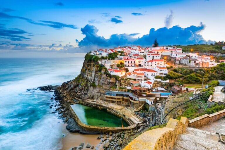 Check out these amazing day trips from Lisbon Portugal recommended by top family travel blog Marcie in Mommyland. Image of Azenhas do Mar, Portugal coastal town.