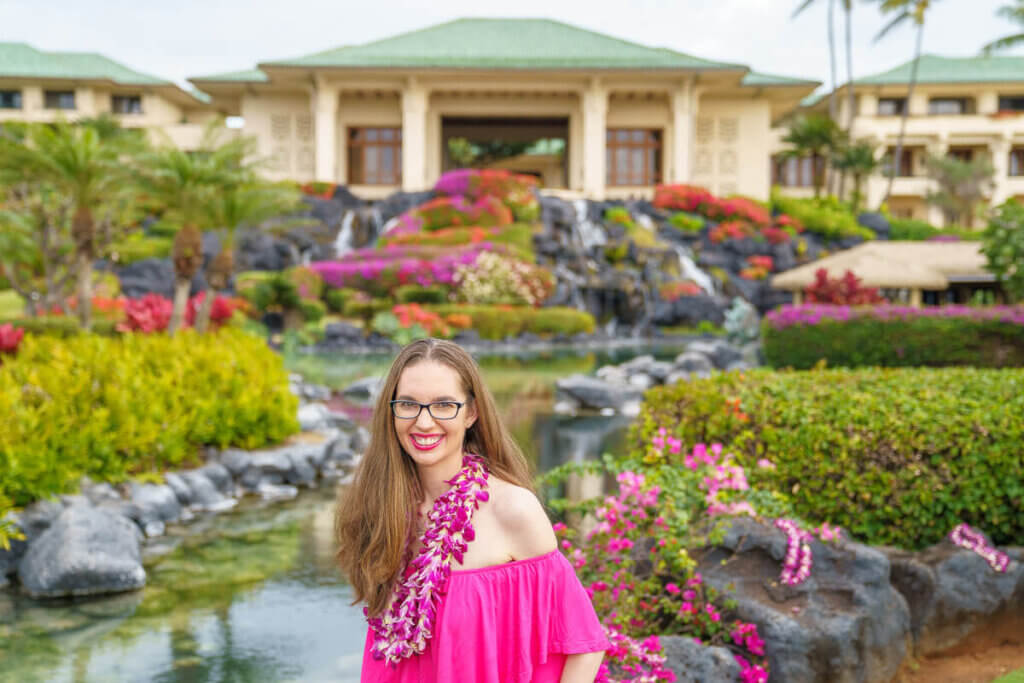 Image of a woman in front of the Grand Hyatt Kauai