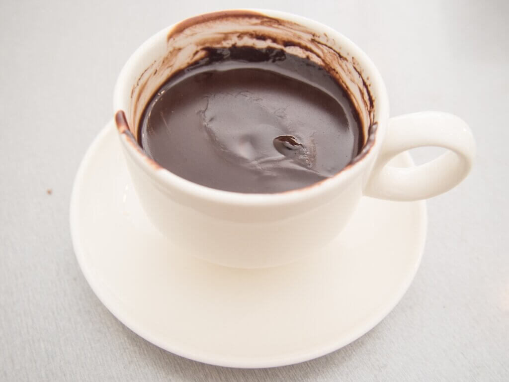 Image of a white mug with thick hot chocolate