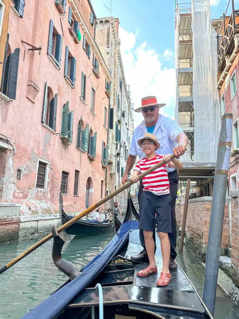 Image of a boy learning how to be a gondolier in Venice Italy