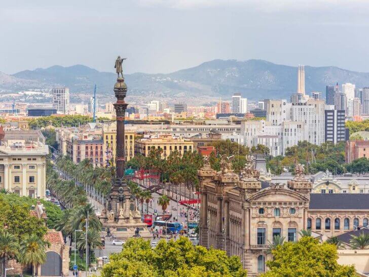 Find out the best Barcelona hotels for families visiting Spain with Kids recommended by top family travel blog Marcie in Mommyland. Image of Aerial view over square Portal de la pau, and Port Vell marina and Columbus Monument in Barcelona, Catalonia, Spain