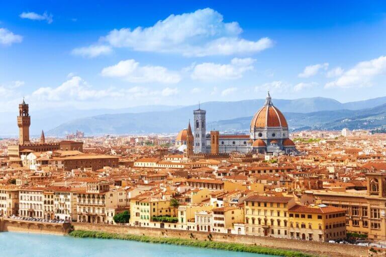 Check out this list of the best Florence hotels for families visiting Italy with kids recommended by top family travel blog Marcie in Mommyland. Image of Cityscape panorama of Arno river, towers and cathedrals of Florence