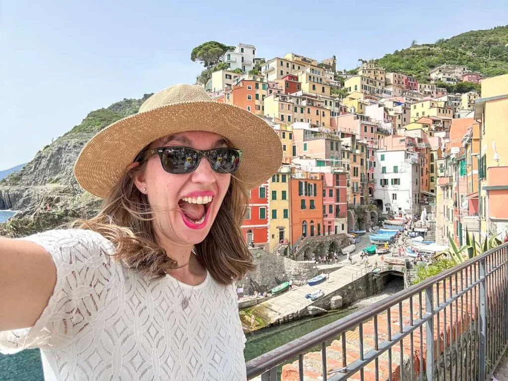 Image of a woman in front of Riomaggiore in Cinque Terre Italy