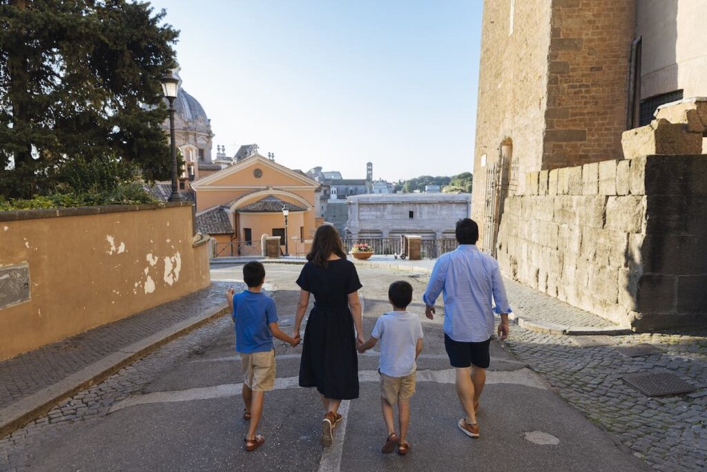 Image of a family of four walking away from the camera during a Rome photography session