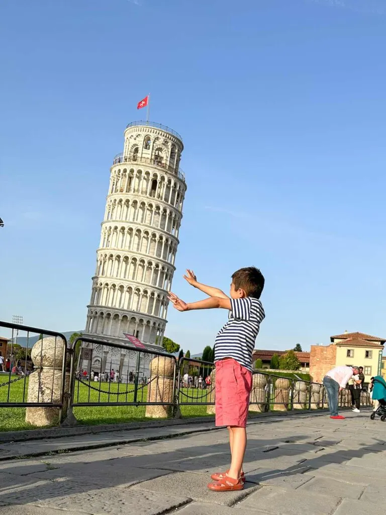Image of a boy holding up the Leaning Tower of Pisa