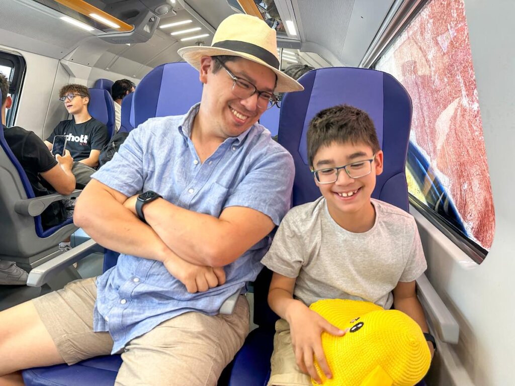 Image of a dad and son on a train to Cinque Terre Italy