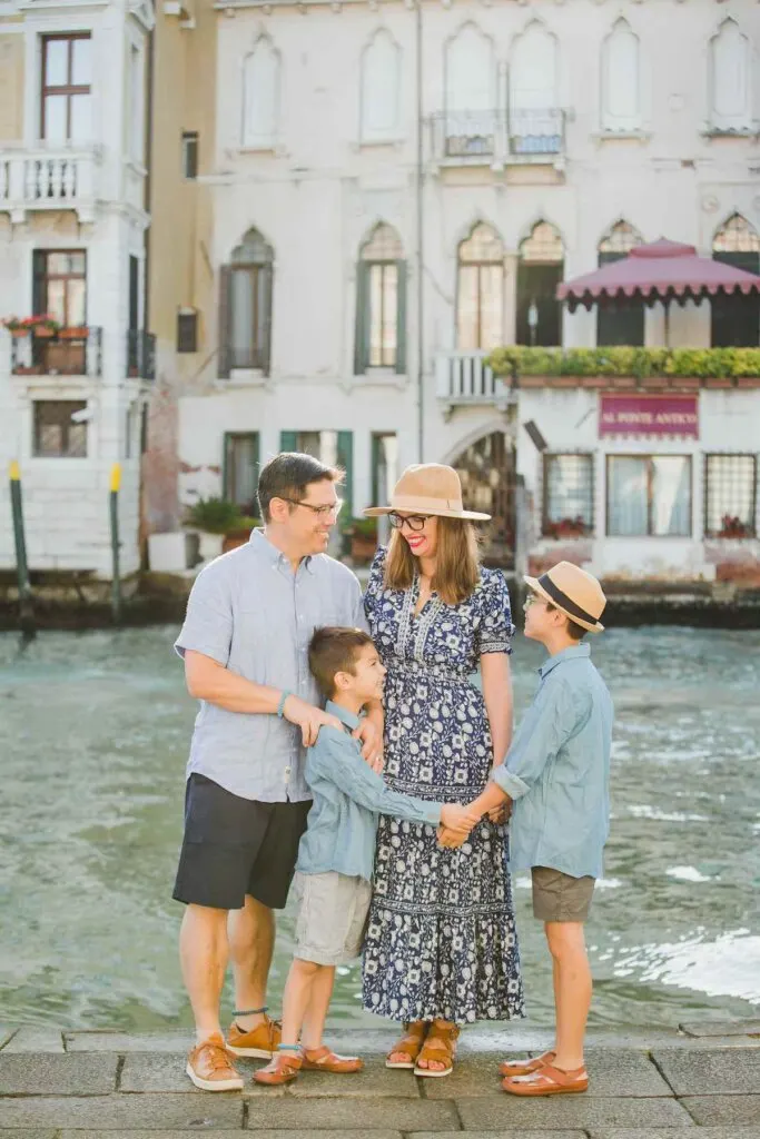 Image of a family looking at each other by a canal in Venice
